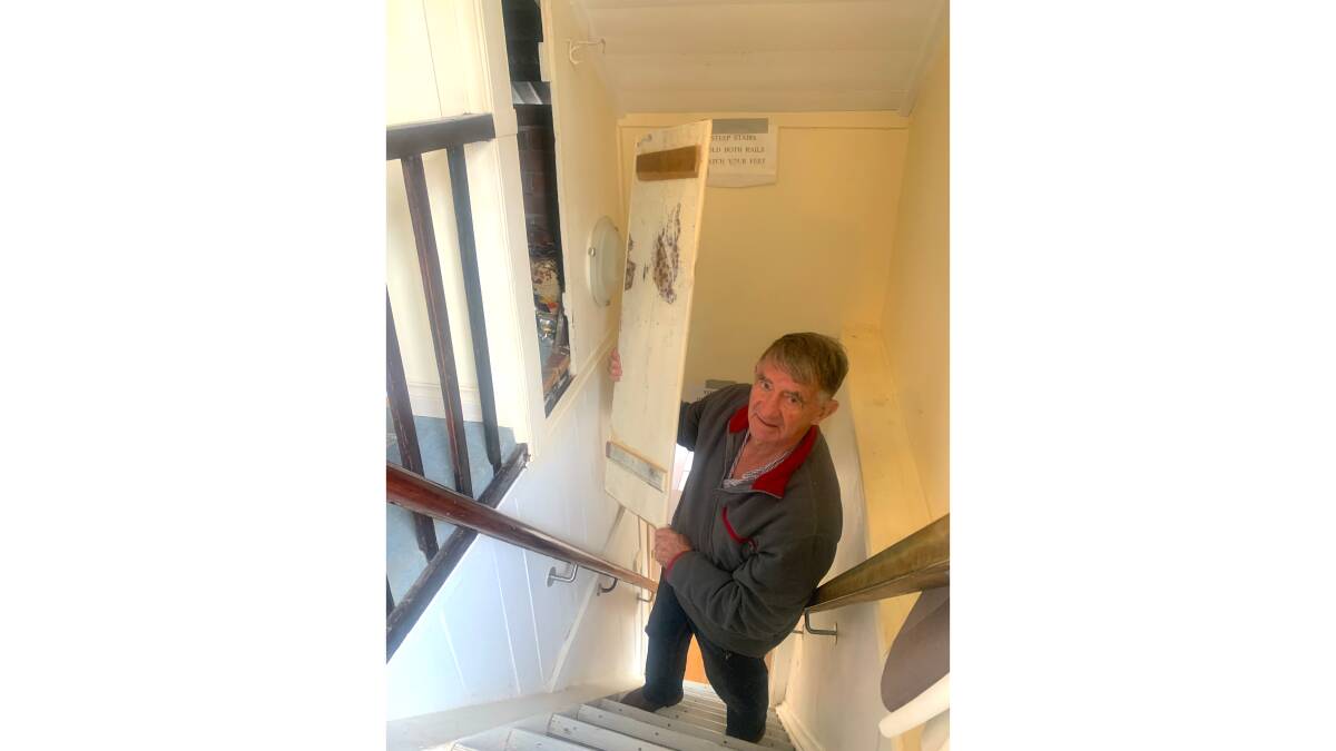 John Feehan reveals the secret bolt hole built into the side of the stairs in the Old Gunsmiths in Braidwood. Picture by Tim the Yowie Man
