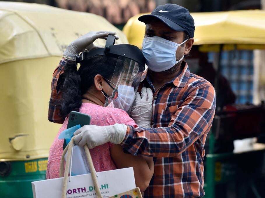 A woman is consoled after a hospital turned away her father from admission into its COVID-19 ward in New Delhi, India this week. Picture: Getty Images