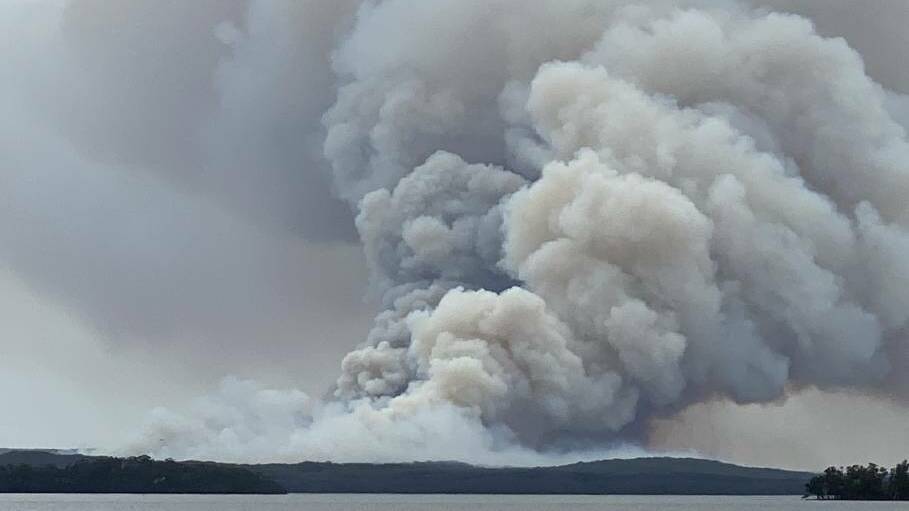 ANGRY MONSTER: John Wardle's incredible photo of the bushfire in the Booderee National Park at Jervis Bay, west of the fire from St Georges Basin looking east.