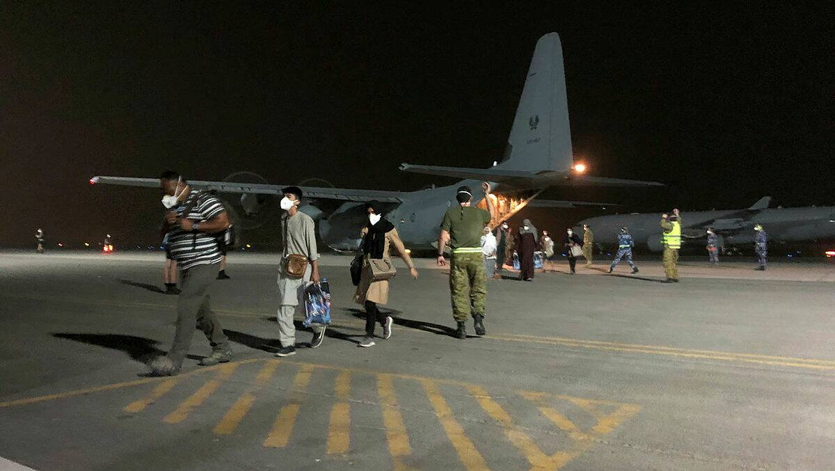 Responding: Evacuees from Kabul arrive at Australia's Middle East air base after being flown from the Afghan capital Kabul this week. Picture: DEFENCE DEPARTMENT
