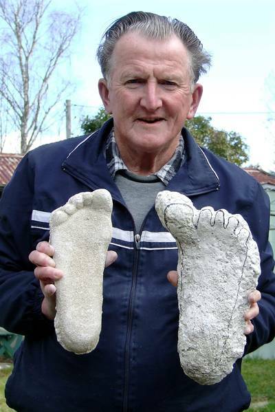 Cryptozoologist Rex Gilroy with a cast of his right foot compared with a left opposable big-toed Australopithecine-type footprint, cast from a Blue Mountains location. Photo copyright Rex Gilroy 2012.