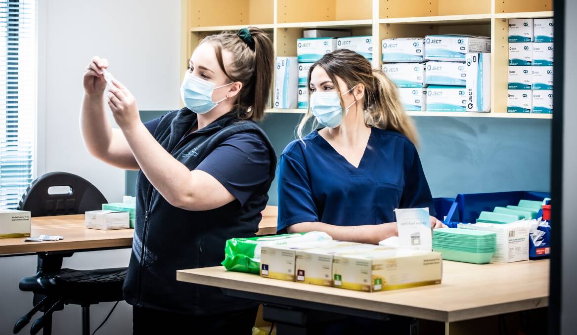 Clinical nurse manager Felicity Manson (left) and senior nurse Siobhan Nurmi make sure Canberra's third mass vaccine hub is stocked and ready to operate. Picture: Karleen Minney