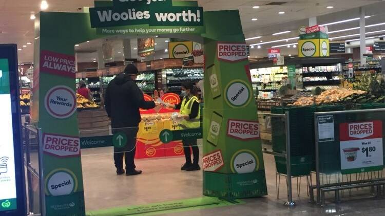 Masks were handed out to customers upon entry to Woolworths Gungahlin.