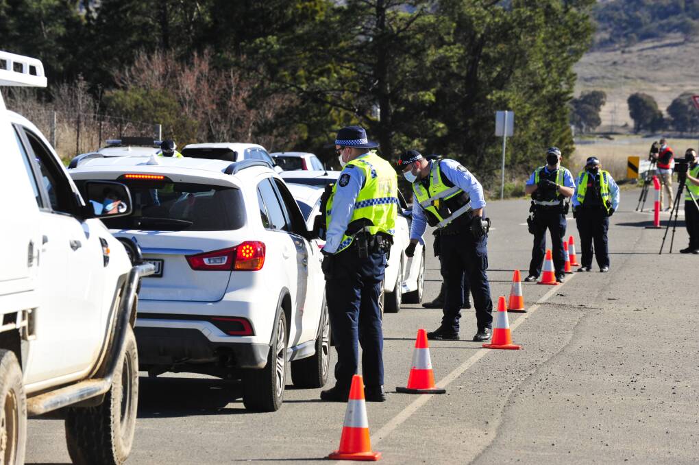 ACT police set up a border checkpoint on Lanyon Drive to check vehicles who are entering into the ACT from Queanbeyan. Picture: Dion Georgopoulos