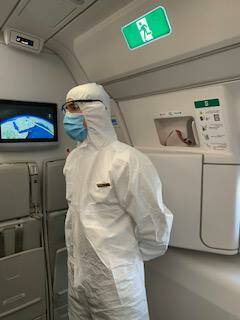 A staff member on Christine Walmsley's flight from Australia to England in June. Picture: Supplied
