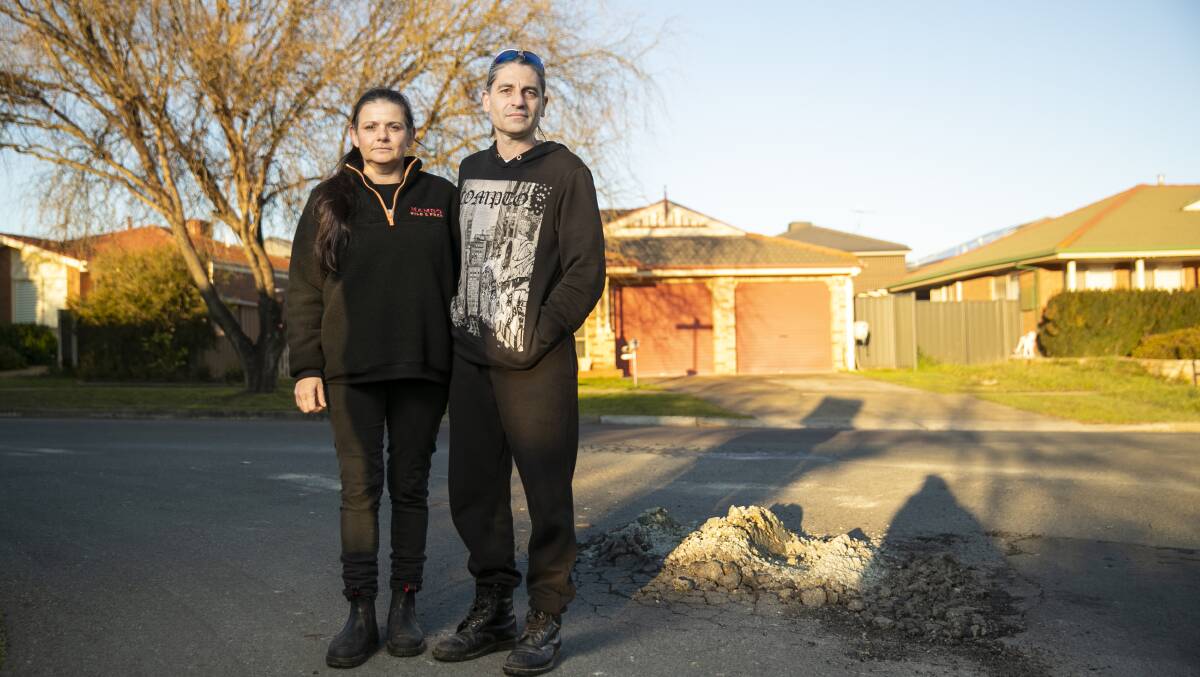 Tarra Place residents Kalli Saimos and Robert Grooby with some of the road issues which are also affecting nearby streets. Picture: Keegan Carroll