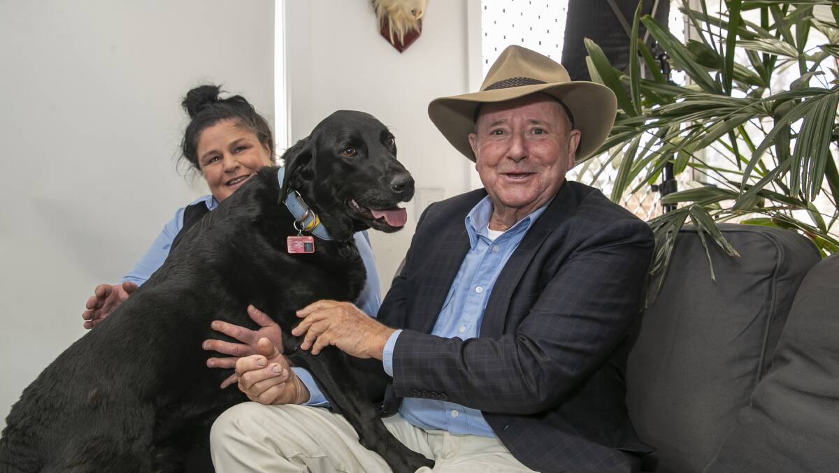 TV vet Dr Harry Cooper with Fraser woman Linda Norris and one of her black Labradors. Picture: Keegan Carroll 
