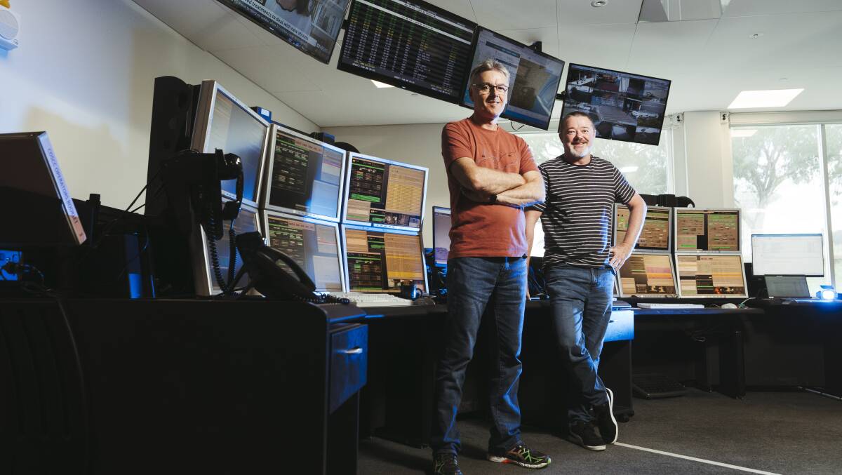 Deep space network link controllers Eddie Prstec and Bill Dengate at the Canberra Deep Space Communication Centre control room. Picture: Dion Georgopoulos 