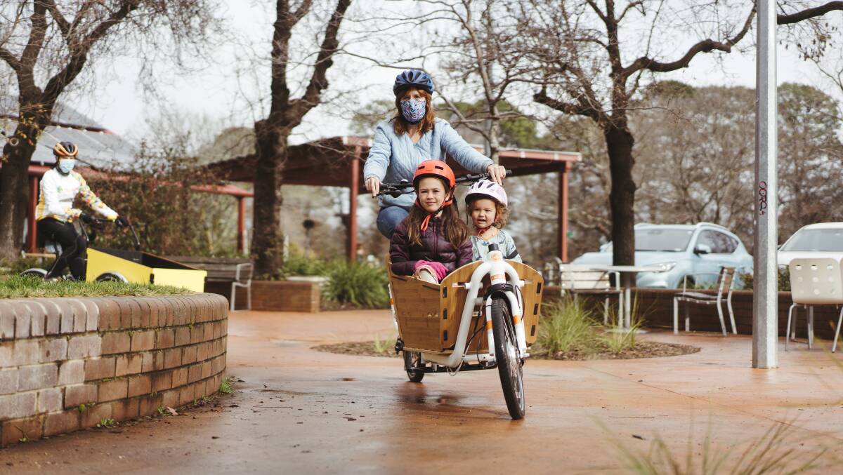 Lucy Hopkins with her two children Lily and Alma, who regularly get around in an electric bike. Picture: Dion Georgopoulos