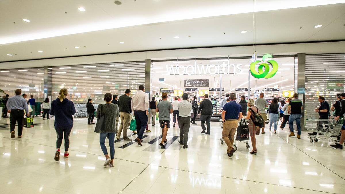 Shoppers queue for the opening hours of Woolworths Majura Park. Picture: Karleen Minney