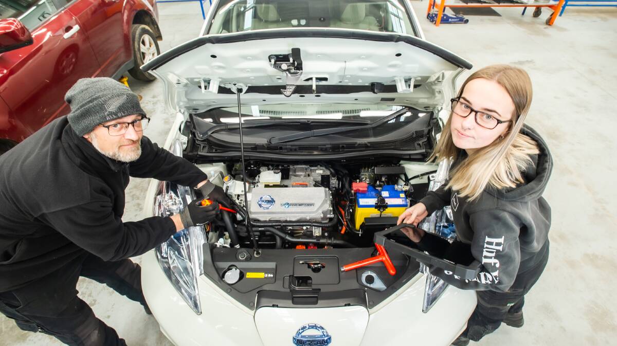 Second-year apprentices Mathew Lovich and Emily Thornton work on an electric car. Picture: Karleen Minney
