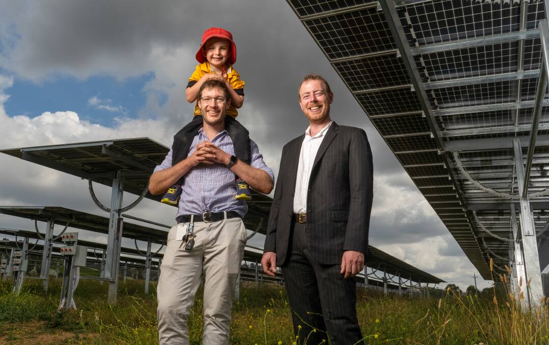 Andrew Thomson with his 6-year-old son Owen, and SolarShare principal executive officer Lawrence McIntosh at the opening of the country's largest community-owned solar farm. Picture: Richard Thompson