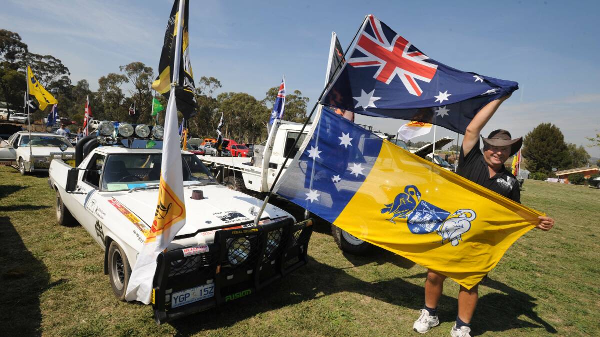 "Most feral ute" entrant David Drady flies the ACT flag at a ute muster in Sutton in 2010. Picture: Richard Briggs