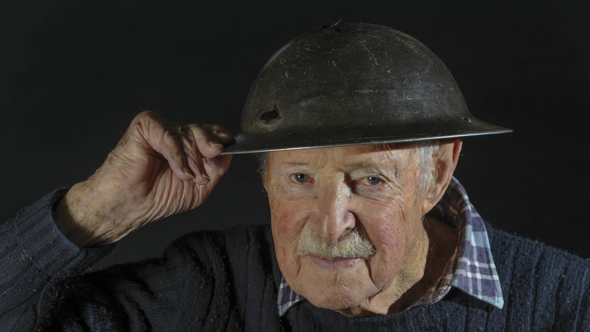 Then 93-year-old WWII veteran Joe Mullins with his bullet-pierced helmet in 2015. Picture by Graham Tidy.