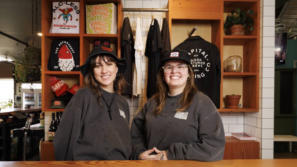 Capital Brewing bartenders Emily Brown and Grace Aboud in brewery branded merchandise. Picture by Keegan Carroll