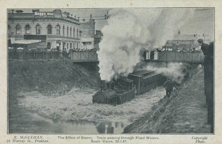 Postcard of a steam locomotive pushing through floodwaters at South Yarra in January 1907. Picture: N.R. McGeehan, NLA