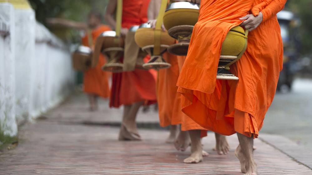 Buddhist monks on their morning constitutional in Luang Prabang, Laos. Picture Shutterstock