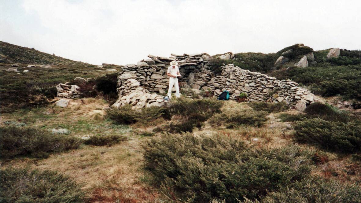 David Scott's 1991 photo of his colleague Allan Bendall at the shelter. Just over Allan's left shoulder you can make out the lintel still in place. Picture: David Scott