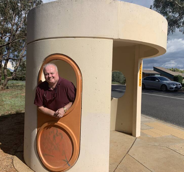 Rohan Goyne at a 45-year-old Clem Cummings-designed bus shelter in Evatt. Picture: Tim the Yowie Man