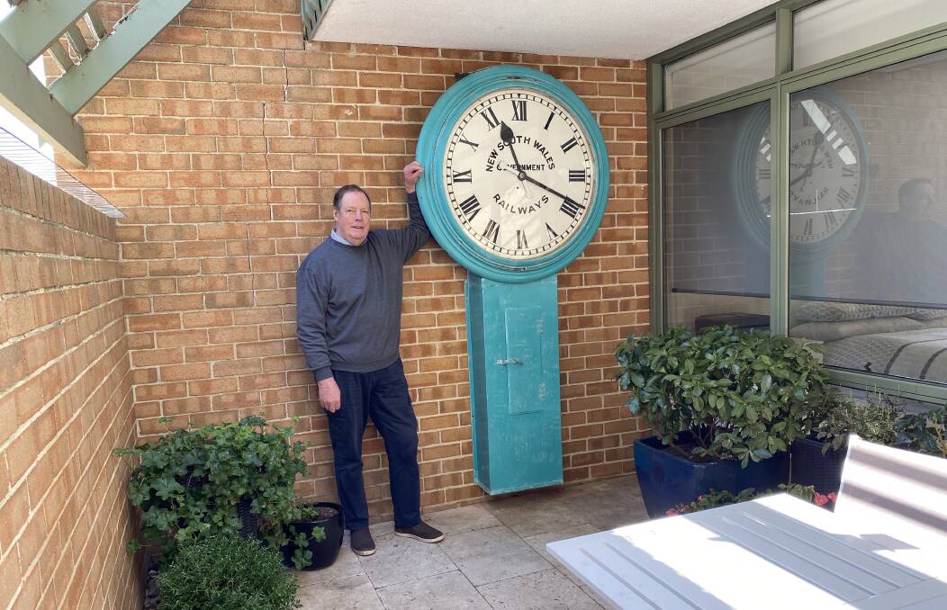 Byam Wight with the circa-1855 railway clock in his Kingston courtyard. Picture: Byam Wight