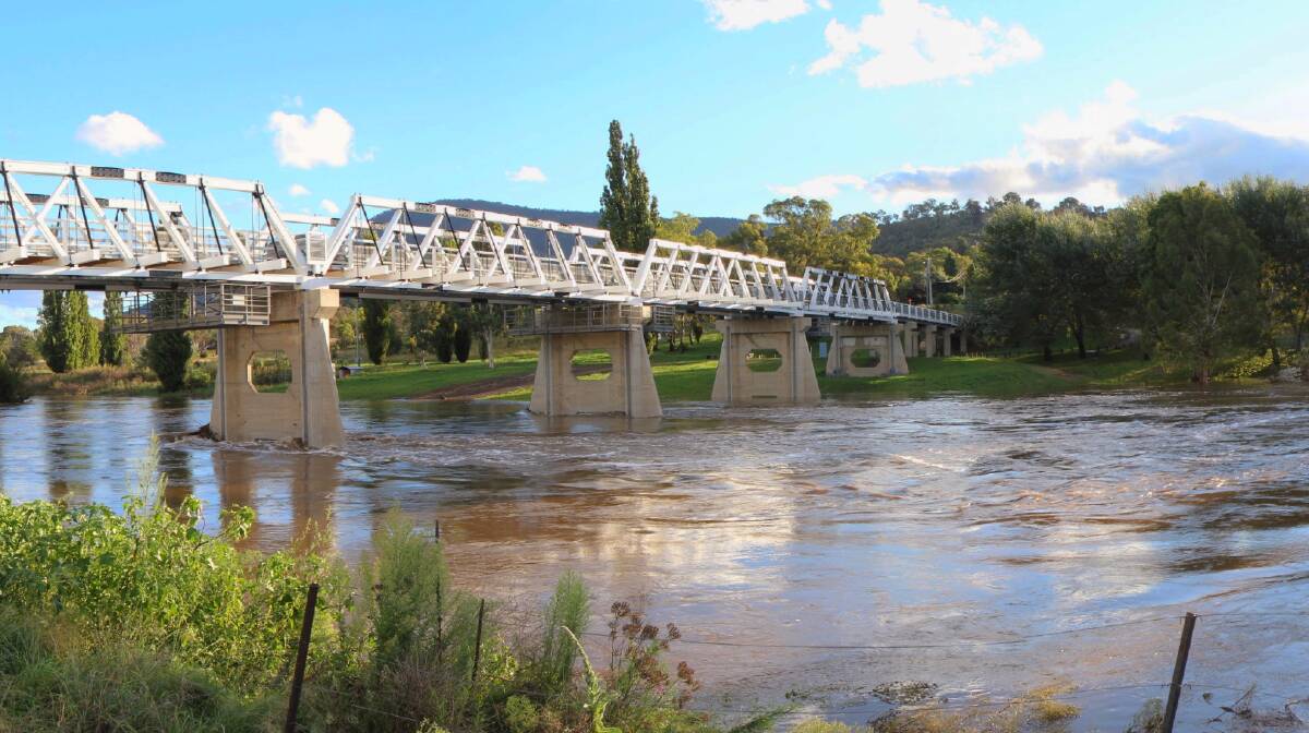 Many floods have flowed beneath the Tharwa bridge, including this one in 2012. Picture by Roman Soroka