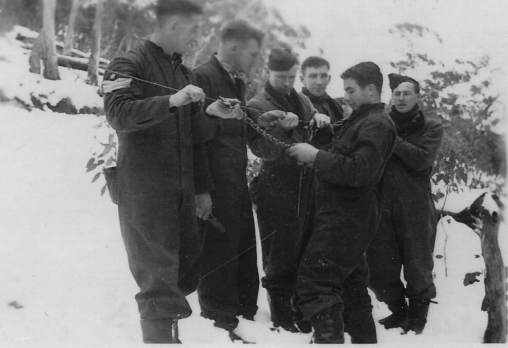 A group of Dutch airmen repair the phone line to the Mt Franklin Chalet in 1942. Picture: Ted Lewis