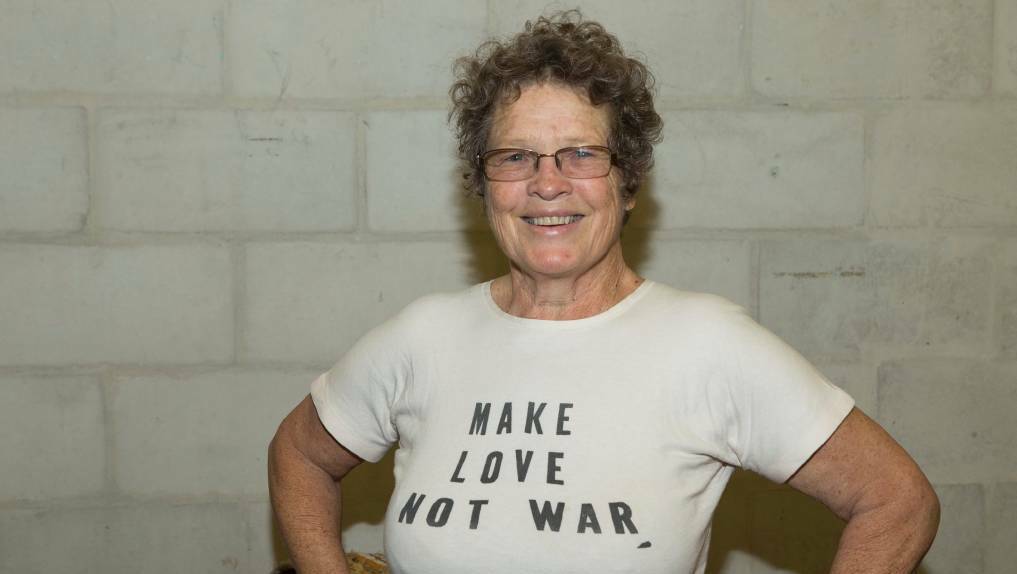 Megan Stoyles in the very T-shirt she wore in 1966 during an anti-Vietnam War protest in Canberra as US president Lyndon Johnson arrived in the national capital. Picture: Stuart Hay, ANU