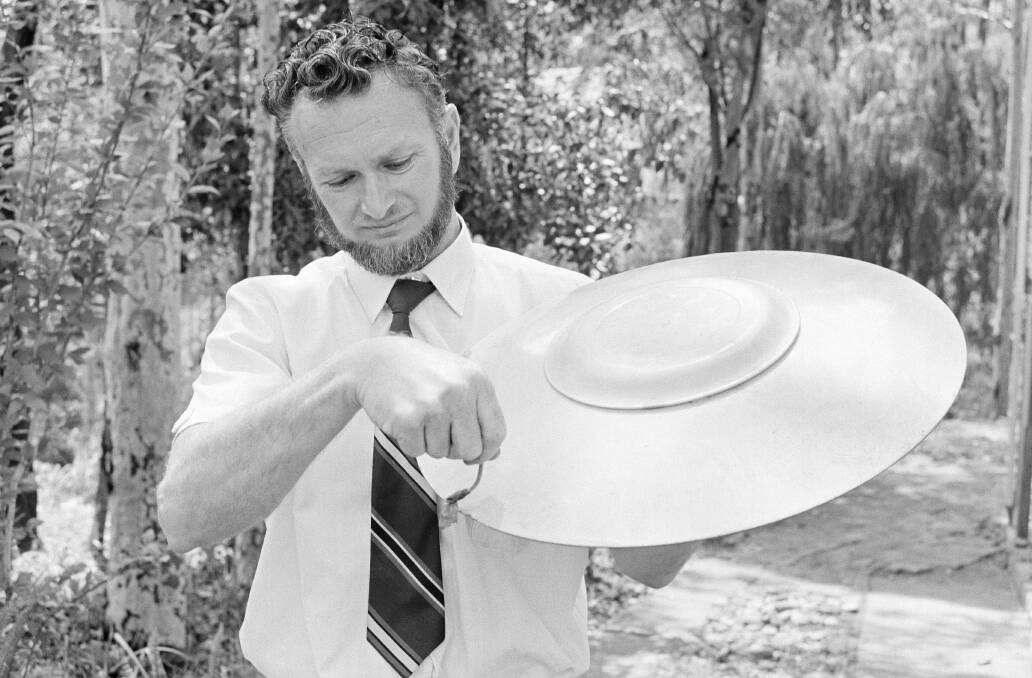 Australian Duane Phillips holding a model of his flying saucer in 1971. Picture: National Archives of Australia (A6180, 3/12/71/29)