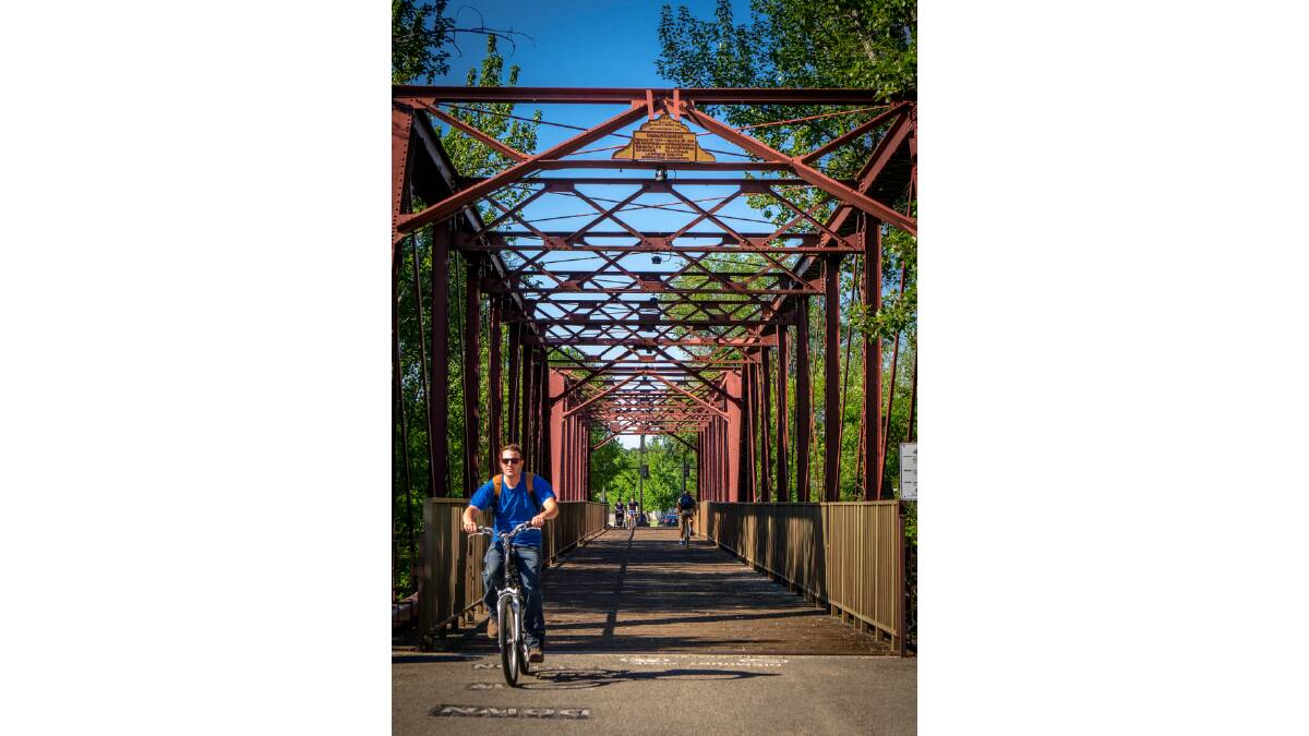 Crossing the historic footbridge along the Boise River Greenbelt. Picture Shutterstock