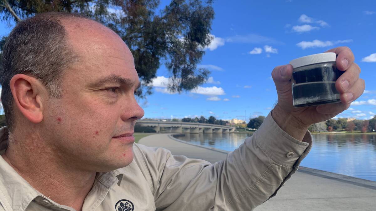 Matthew Beitzel holds preserved freshwater jellyfish collected from Googong Dam in May 2000. Picture: Tim the Yowie Man