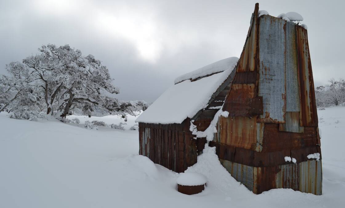 Four Mile Hut wearing its winter cloak after a big snowfall in 2014. Picture: Peter Meusburger