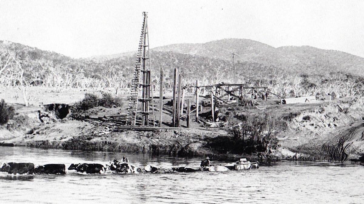 Tharwa Bridge under constructions circa 1884. You can see bullocks drawing a cart through the water.
