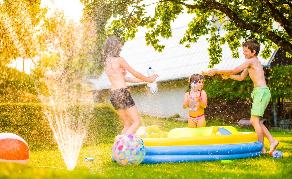 Watering the lawn doesn't have to be boring if you get the family involved. Picture: Shutterstock