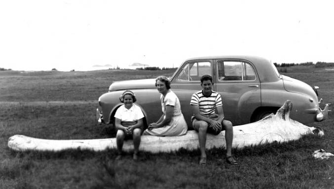 Malcolm Morgan, with sister Maree and mother Lorna, take a rest on the Long Beach Whale Bone, circa 1951. Picture by Eddie Morgan