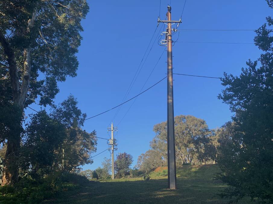 The lonely stobie pole (foreground) on Red Hill, near the Deakin Offices. Picture: Tim the Yowie Man