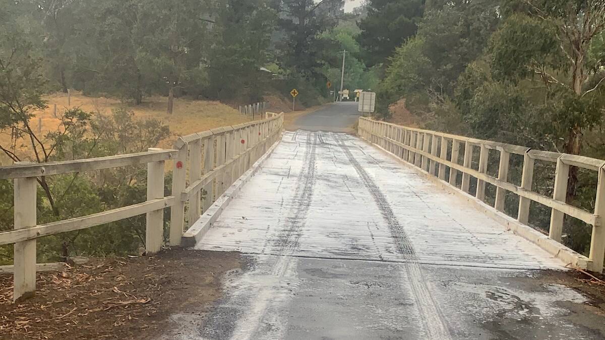 The historic Mongarlowe Bridge coated in fire retardant as a precaution during the 2019-20 Black Summer fires. Picture by Steven Hockey