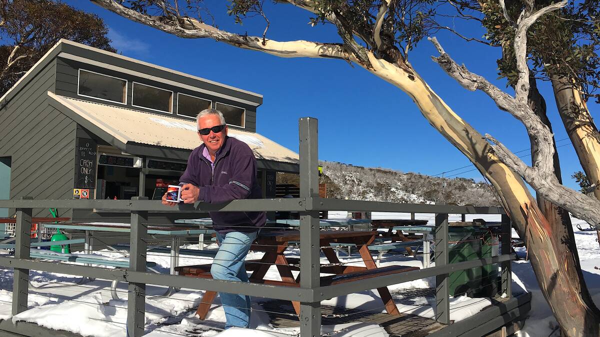 Steve Young enjoys a morning cuppa on the deck of the Alpine Eyre near Perisher.