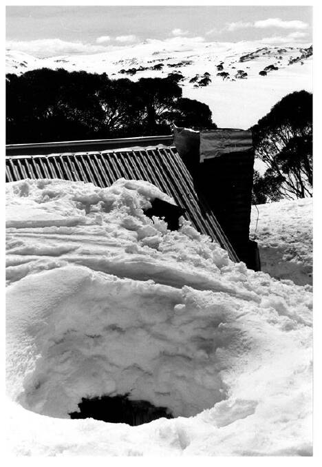 Deep holes were dug in the snow in the winter of 1981 to allow light into the windows of Mawsons Hut in Kosciuszko National Park. Picture: Klaus Hueneke Collection, NAMA