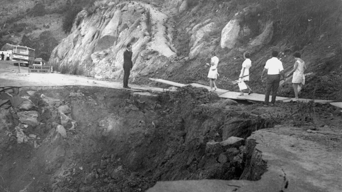 After a landslide in 1971, tracking station staff had to 'walk the plank' before heading home to Canberra in buses. Picture by Hamish Lindsay and Colin Mackellar