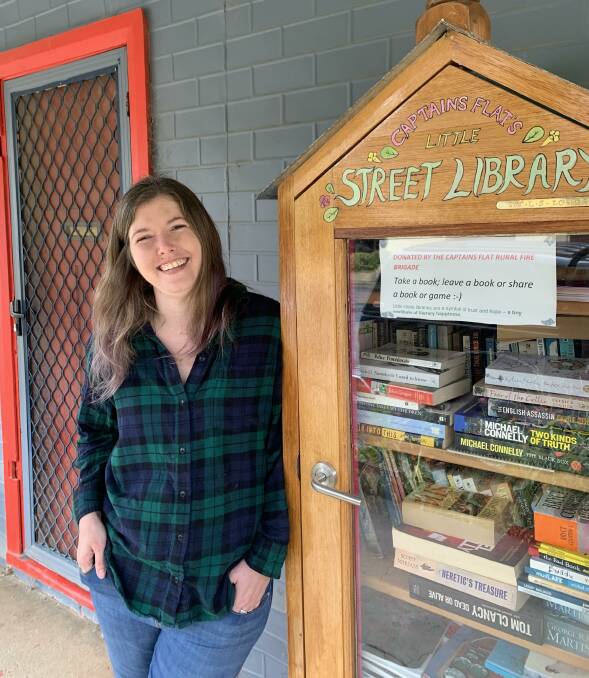 Postmistress-cum-gallery owner Christina Steele at the street library out the front of her 'Neverwhere Gallery'. Picture by Tim the Yowie Man