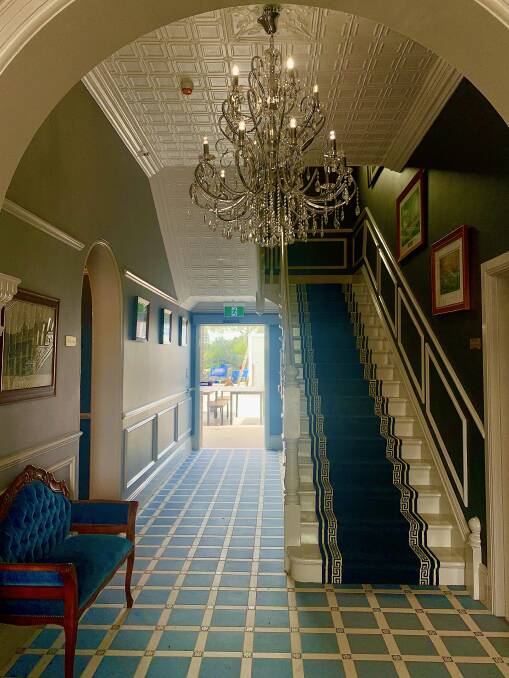 A corridor featuring a crystal chandelier. Picture by Tim the Yowie Man