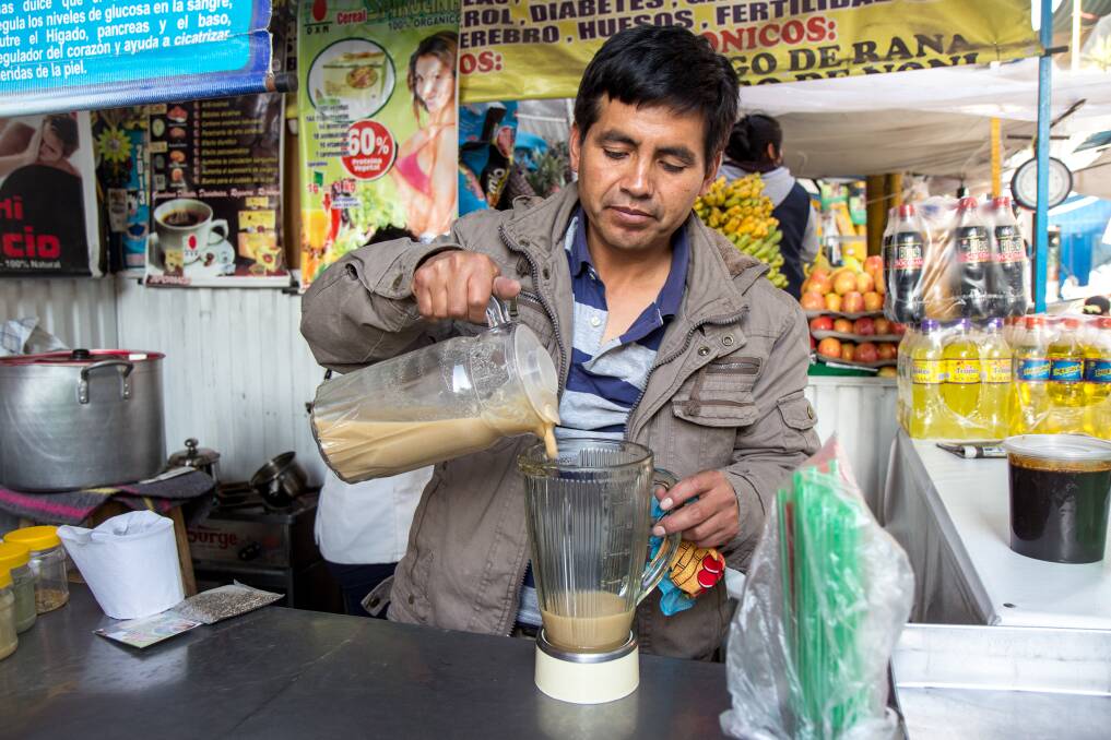 A man prepares some frog juice at a market stall in Arequipa, Peru.