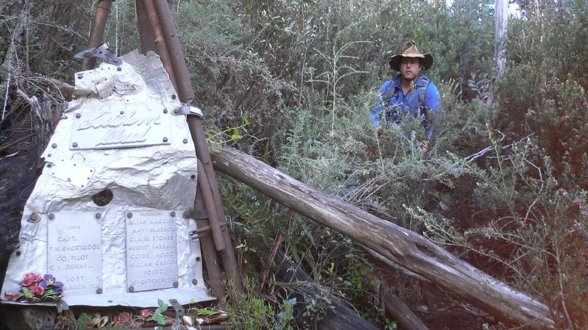 Tim inspects the bush memorial at the site of the wreck in 2013. Picture by Matthew Higgins