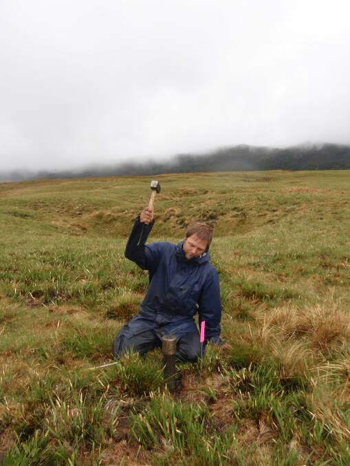 Matt Taylor from the The Tasmanian Land Conservancy sampling soil in the Cradle Mountain area. Picture: Supplied