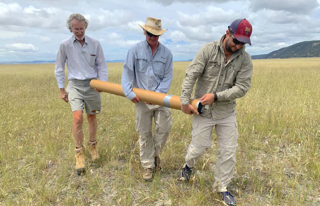 ANU scientists Brad Pillans, Bradley Opdyke and Chris Gouramanis lug a core sample across Lake George. Picture: Tim the Yowie Man