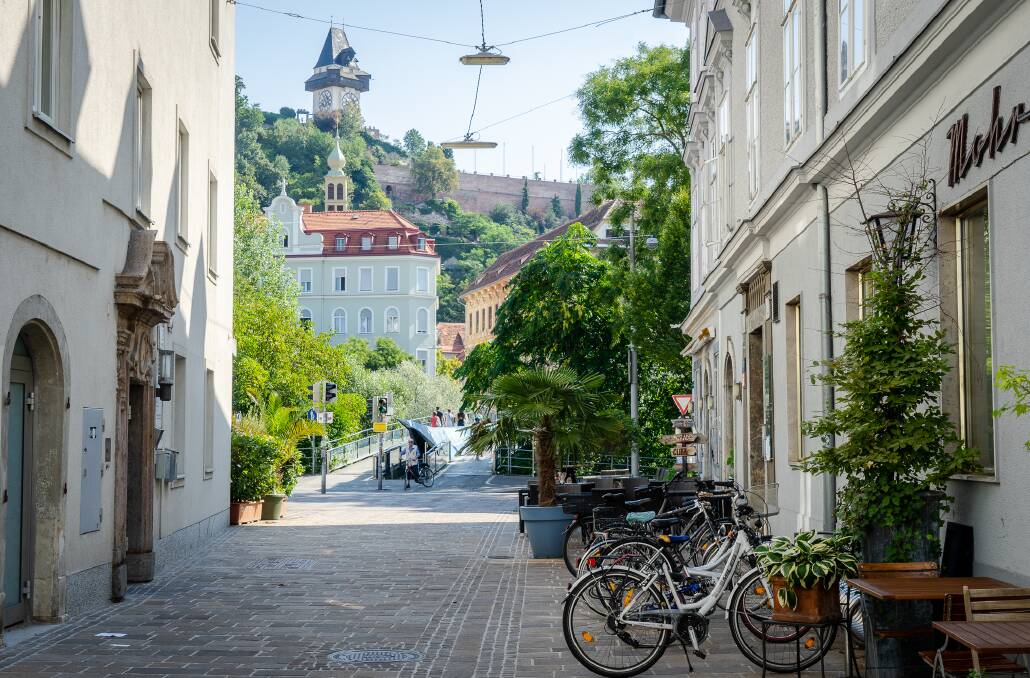 The trendy area of Lend with the iconic Schlossberg landmark in the background.