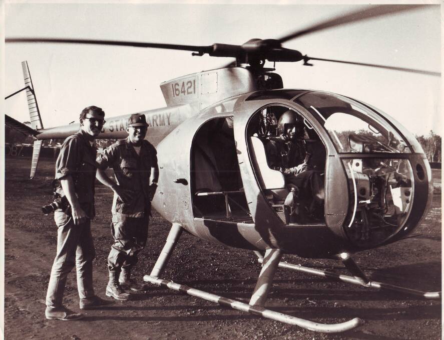 Boarding a US Army chopper on assignment north of Saigon.