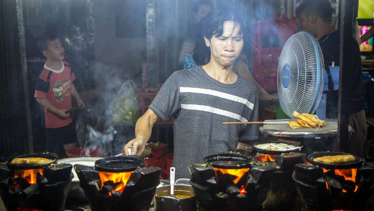 Street food being cooked on the footpath in Ho Chi Minh City. 