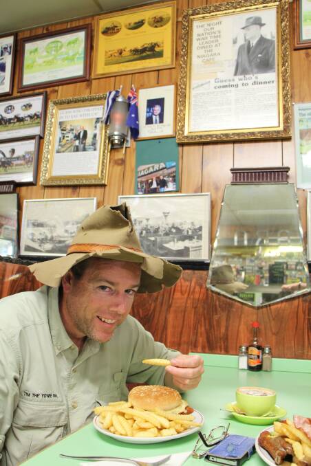 Tim enjoys a burger in one of the booths at the Niagara Cafe in 2014. Picture: Dave Moore