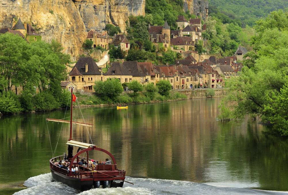 A traditional gabarre boat passes La Roque-Gageac on the Dordogne River. Pictures: Getty Images